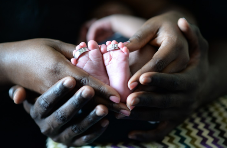 parents holding a baby